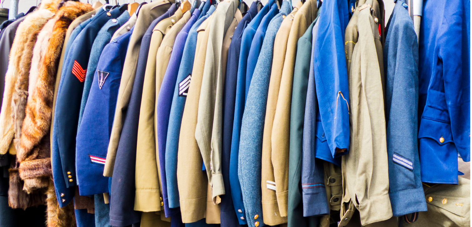 A row of jackets hanging on a rack in a store.