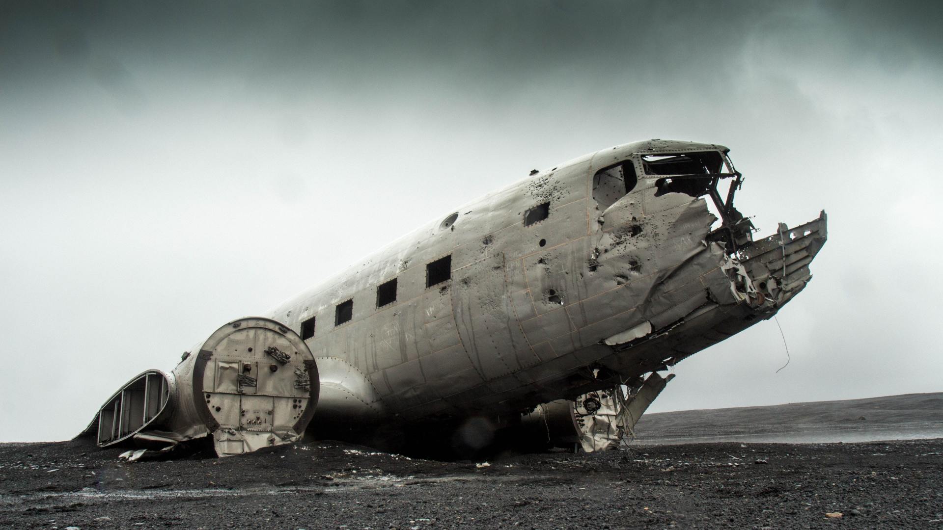 A black and white photo of a wrecked airplane on the ground.