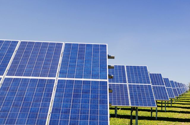 A row of solar panels against a blue sky