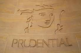 A logo for prudential is carved into a stone wall.
